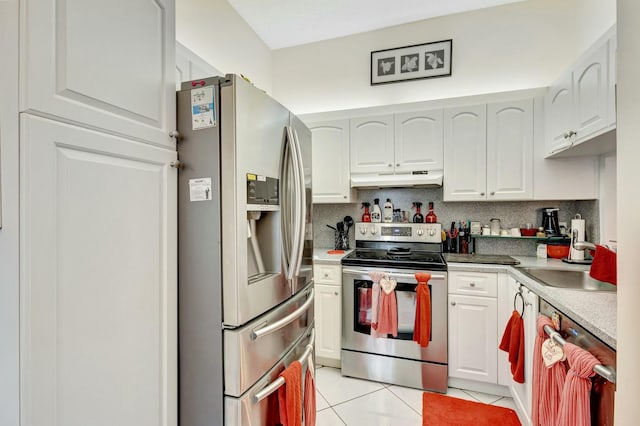 kitchen with light tile patterned floors, under cabinet range hood, stainless steel appliances, a sink, and tasteful backsplash