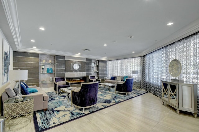 living room with visible vents, ornamental molding, a glass covered fireplace, and recessed lighting