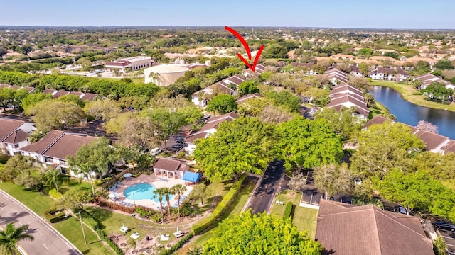 birds eye view of property with a water view and a residential view