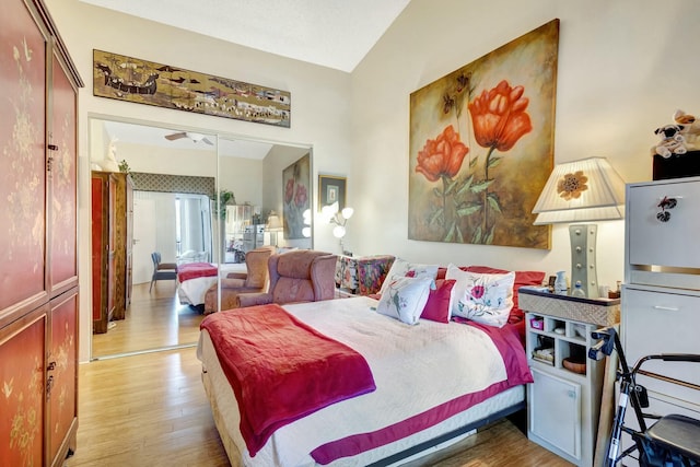 bedroom with vaulted ceiling and wood finished floors