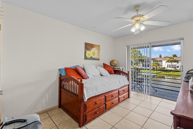 bedroom with baseboards, a ceiling fan, access to outside, a textured ceiling, and light tile patterned flooring