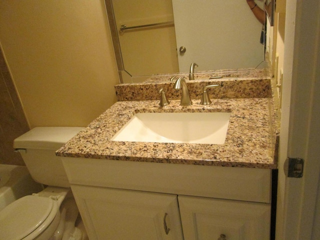 bathroom featuring toilet and vanity