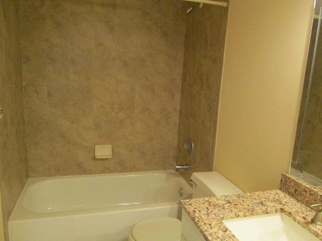 bathroom featuring shower / bathing tub combination, vanity, and toilet