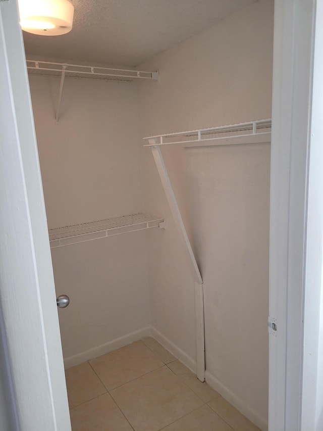 spacious closet with light tile patterned flooring