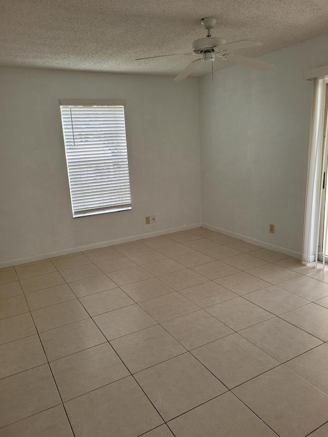 empty room with baseboards, a textured ceiling, and ceiling fan