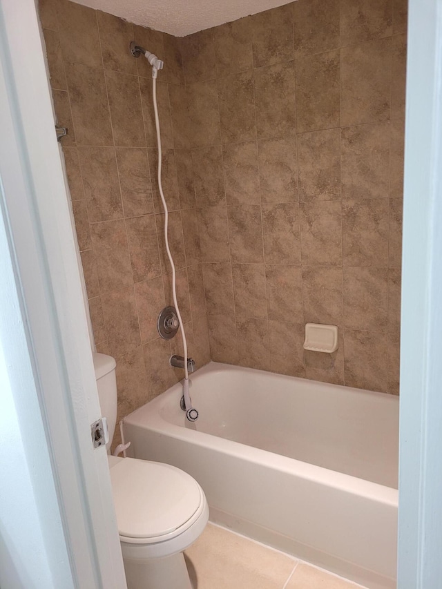 bathroom with tile patterned floors, toilet, and shower / bathing tub combination