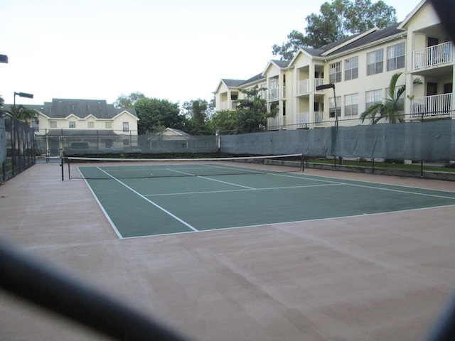 view of sport court featuring fence