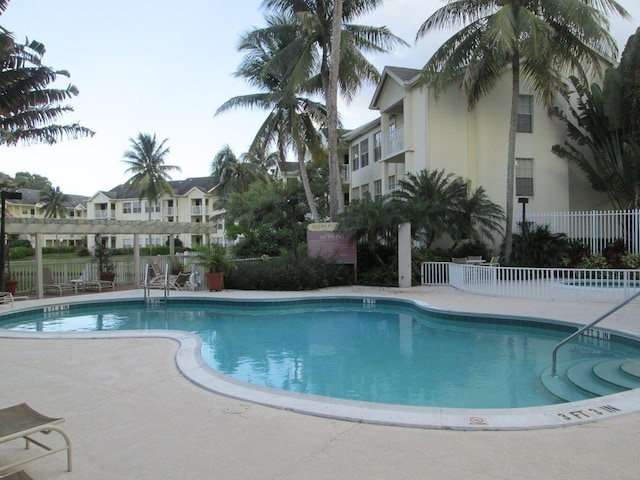 pool featuring a patio area and fence