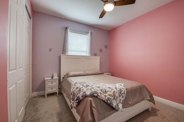 carpeted bedroom with a closet, ceiling fan, and baseboards