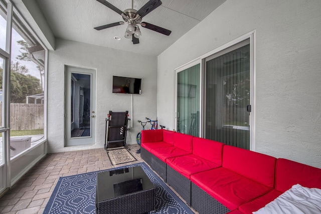 sunroom featuring ceiling fan