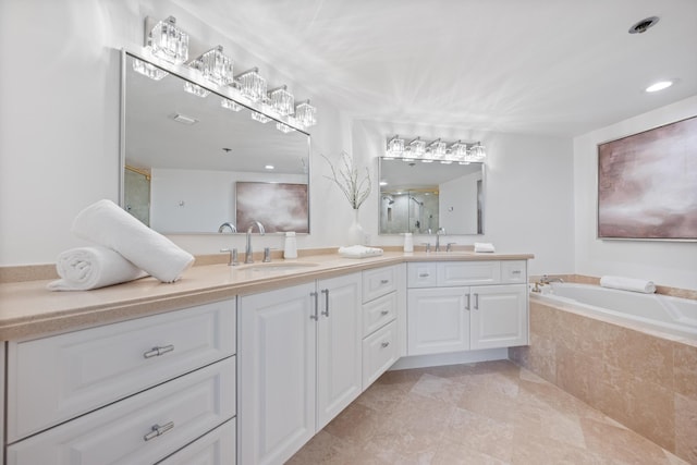 bathroom featuring a stall shower, a garden tub, a sink, and double vanity