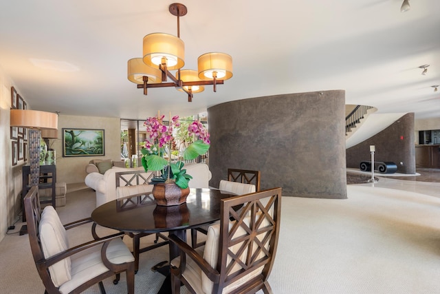 dining room featuring an inviting chandelier, stairs, and carpet flooring