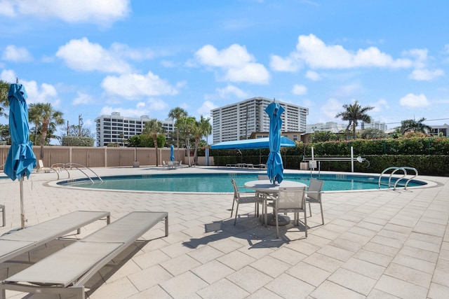 pool featuring a patio and fence