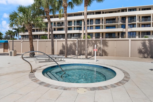 view of swimming pool featuring a hot tub