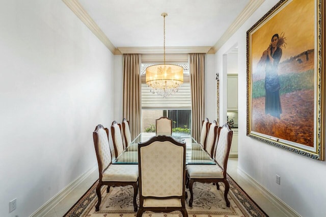 dining area with a notable chandelier, baseboards, and crown molding