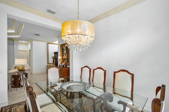 dining space with tile patterned flooring, a notable chandelier, visible vents, baseboards, and ornamental molding