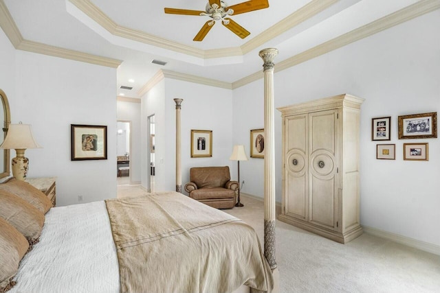 bedroom featuring ornamental molding, a tray ceiling, light carpet, and baseboards