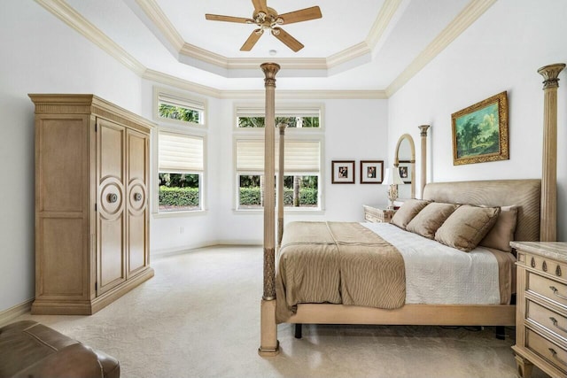 bedroom featuring crown molding, a tray ceiling, and light colored carpet