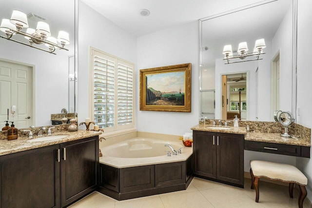 bathroom with a garden tub, two vanities, a sink, and tile patterned flooring