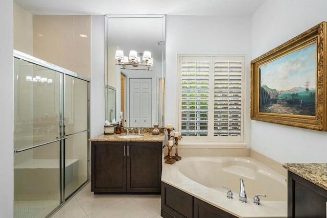 bathroom featuring a stall shower, tile patterned floors, a garden tub, and vanity