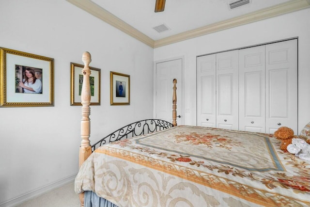 bedroom with ornamental molding, a closet, carpet, and visible vents