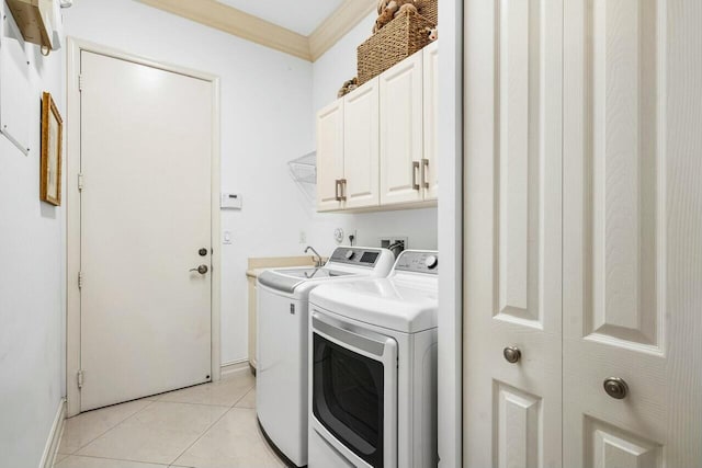 washroom featuring cabinet space, light tile patterned floors, ornamental molding, and separate washer and dryer