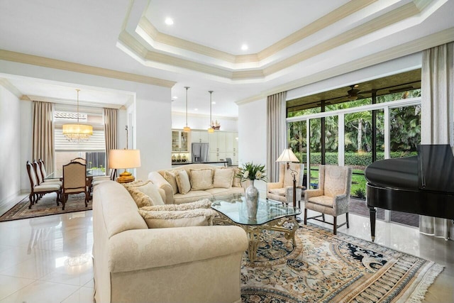 living area featuring light tile patterned floors, a raised ceiling, ornamental molding, ceiling fan with notable chandelier, and recessed lighting