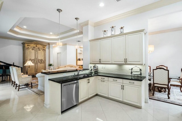 kitchen with dishwasher, dark countertops, decorative light fixtures, a peninsula, and a tray ceiling