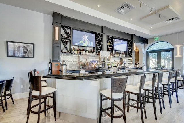 bar featuring a community bar, recessed lighting, visible vents, and light wood-style flooring