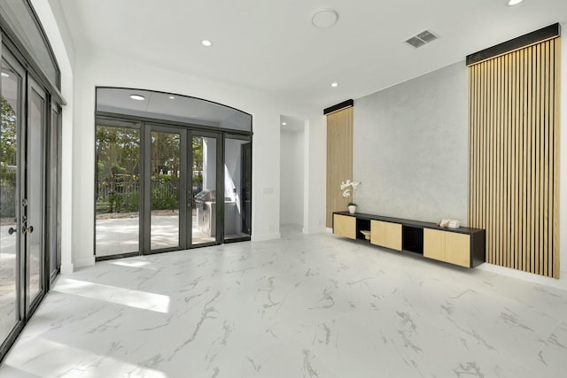 interior space with marble finish floor, recessed lighting, visible vents, and french doors