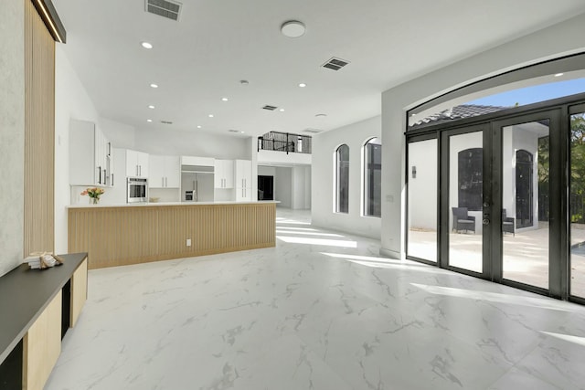 interior space with marble finish floor, visible vents, french doors, and recessed lighting