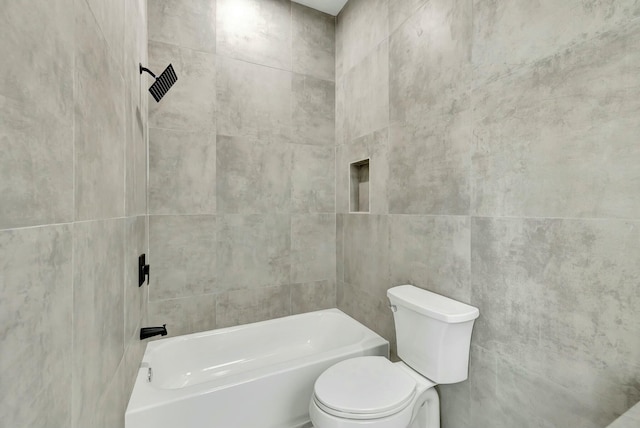 bathroom with shower / tub combination, toilet, and tile walls