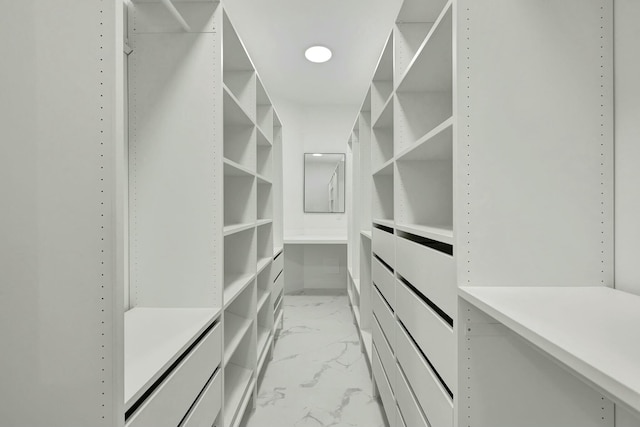 spacious closet with marble finish floor