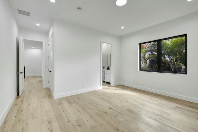 spare room with recessed lighting, visible vents, light wood-style flooring, and baseboards