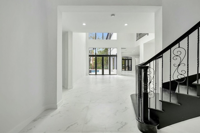 staircase featuring marble finish floor, recessed lighting, and baseboards