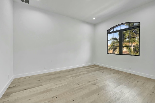 spare room with light wood-style floors, recessed lighting, and baseboards