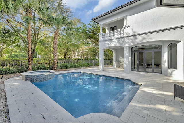 view of swimming pool featuring a patio, french doors, fence, and a pool with connected hot tub