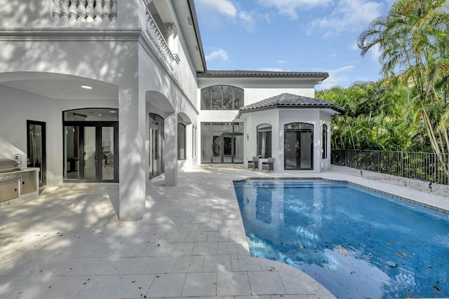 view of swimming pool featuring area for grilling, fence, french doors, a fenced in pool, and a patio area