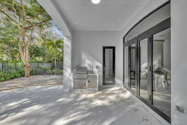 view of patio featuring fence and area for grilling