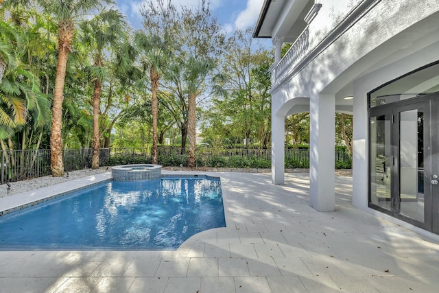 view of pool with a patio area, french doors, a fenced backyard, and a pool with connected hot tub