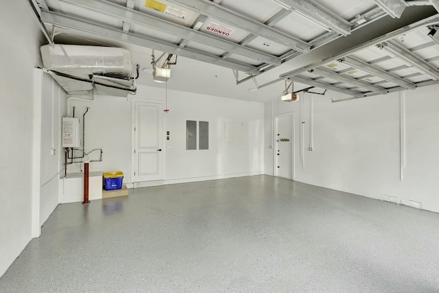 garage featuring water heater, electric panel, and a garage door opener