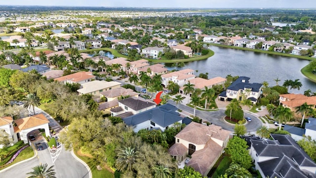 drone / aerial view featuring a residential view and a water view