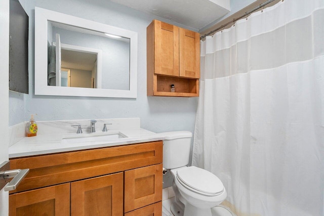 bathroom with toilet and vanity