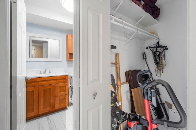 interior space with marble finish floor and a sink