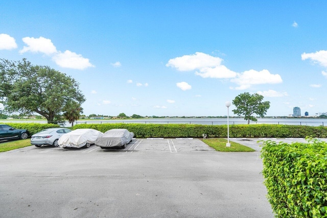 uncovered parking lot with a water view