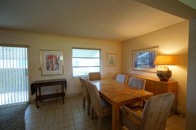 dining room featuring a textured ceiling and light tile patterned flooring