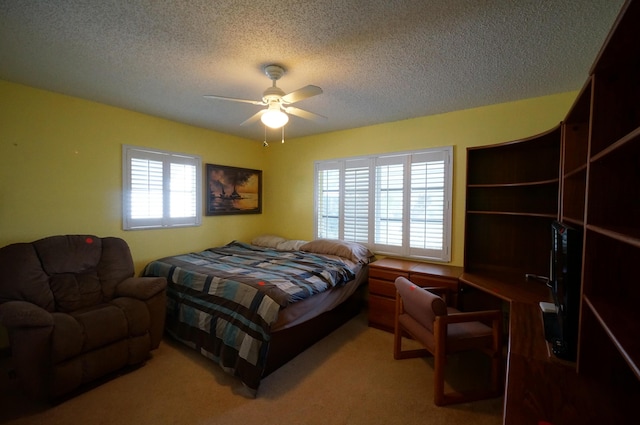 bedroom featuring a textured ceiling, multiple windows, and carpet flooring