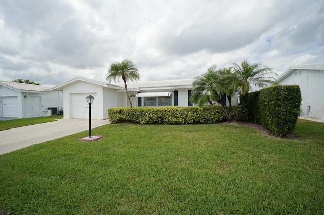 single story home featuring driveway, an attached garage, central AC unit, and a front lawn