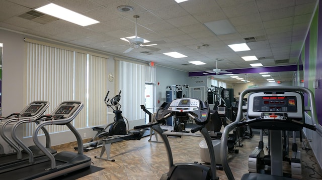 exercise room with visible vents, ceiling fan, and a drop ceiling