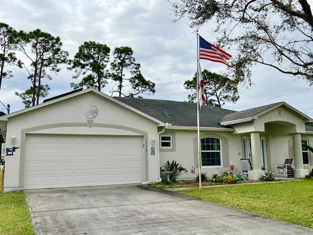 single story home featuring concrete driveway, a garage, a front yard, and stucco siding